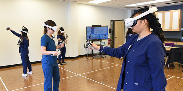 Nursing students with VR headsets.